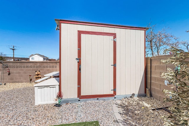 view of shed with a fenced backyard