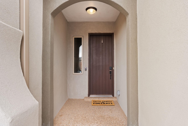 view of exterior entry featuring stucco siding