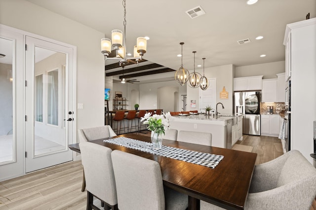 dining area with ceiling fan with notable chandelier, visible vents, light wood-type flooring, and recessed lighting
