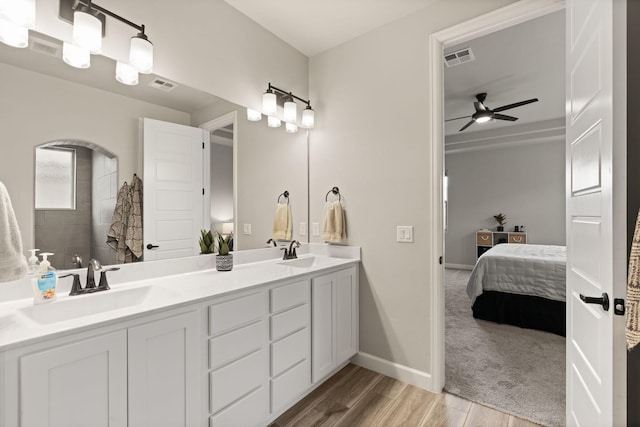 bathroom featuring visible vents, connected bathroom, ceiling fan, and a sink