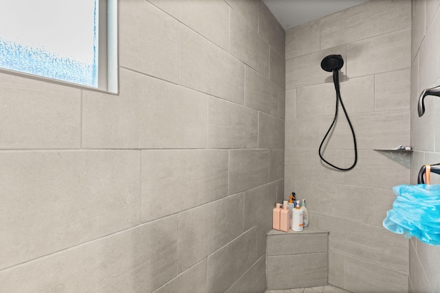 bathroom with a tile shower