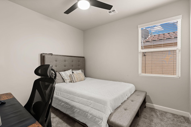 carpeted bedroom with baseboards, visible vents, and ceiling fan