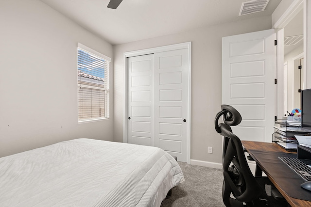 bedroom featuring carpet flooring, visible vents, baseboards, a closet, and a ceiling fan