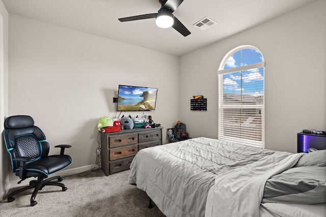 bedroom featuring visible vents, baseboards, ceiling fan, and carpet flooring