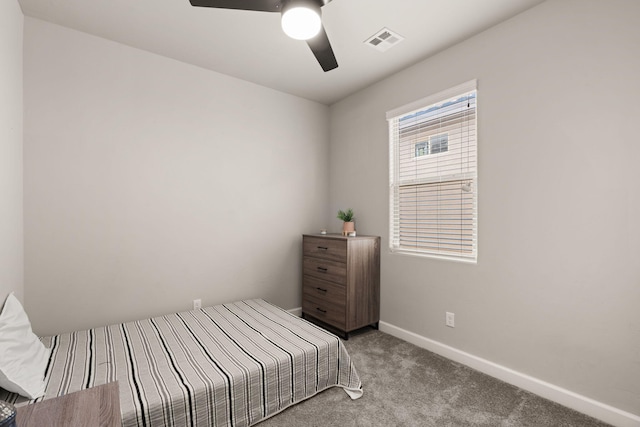 carpeted bedroom featuring visible vents, baseboards, and a ceiling fan