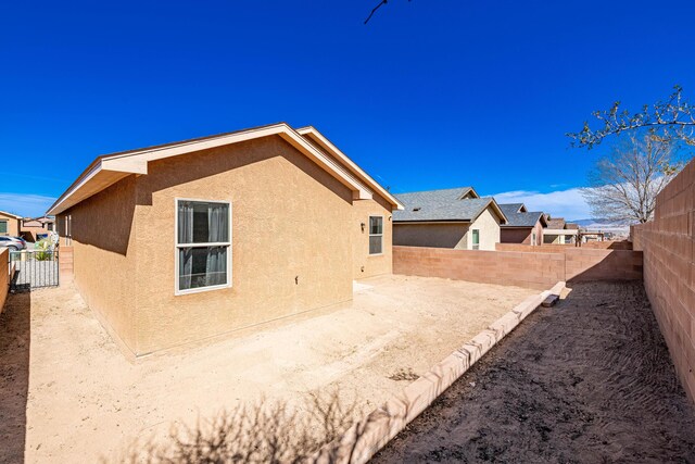 back of property featuring a patio area, stucco siding, and a fenced backyard