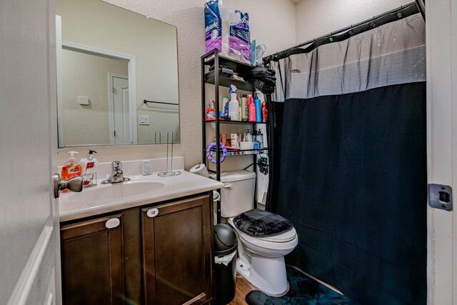 bathroom featuring curtained shower, toilet, vanity, and wood finished floors