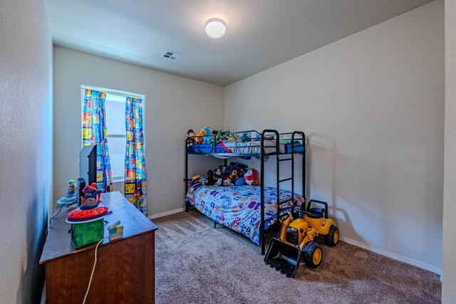 bedroom with carpet flooring, baseboards, and visible vents