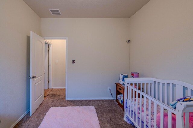 carpeted bedroom featuring visible vents and baseboards