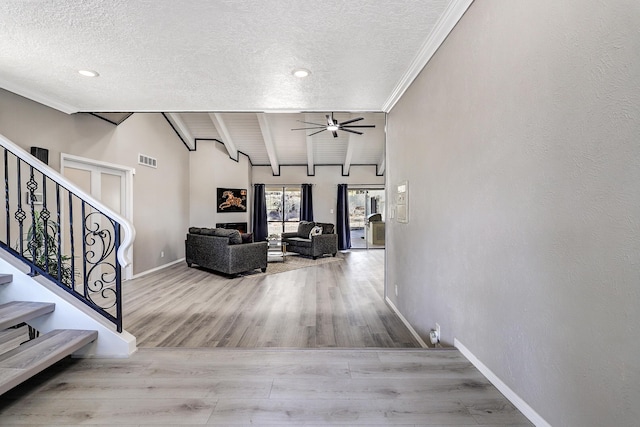 corridor featuring wood finished floors, visible vents, baseboards, lofted ceiling with beams, and stairs