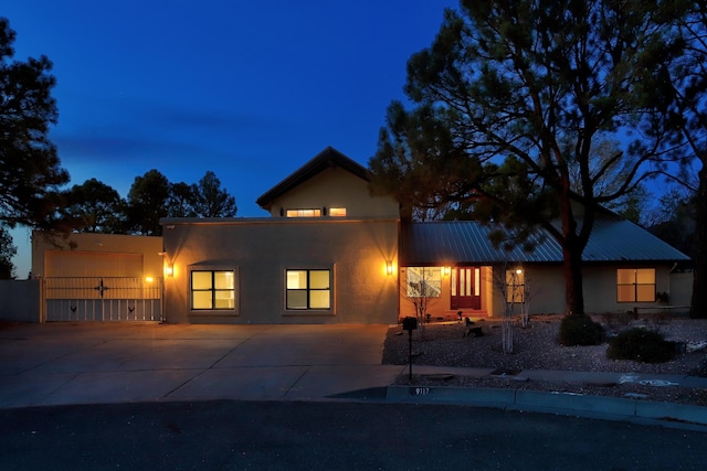 view of front of property with stucco siding and metal roof