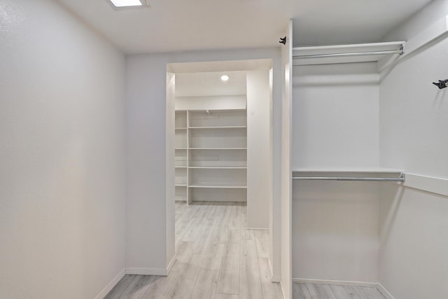 walk in closet featuring wood finished floors