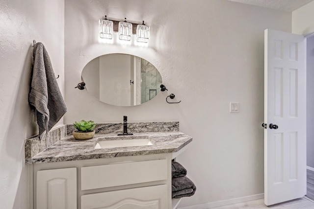 bathroom featuring baseboards and vanity