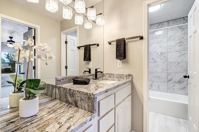 full bathroom with ceiling fan, vanity, and  shower combination