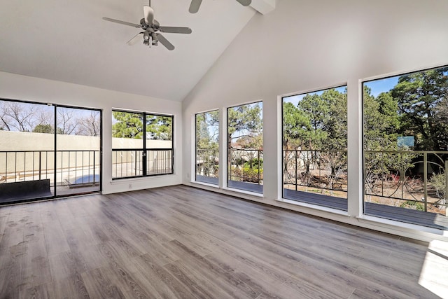 unfurnished sunroom with ceiling fan and vaulted ceiling