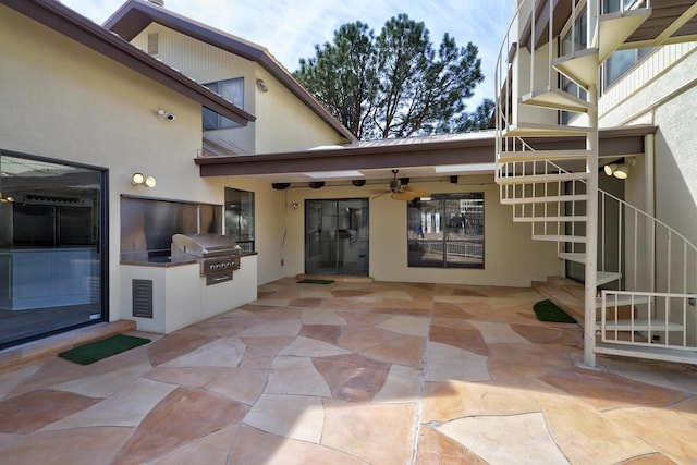 view of patio / terrace with stairs, exterior kitchen, and grilling area