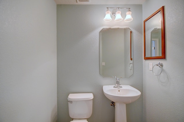 half bath featuring visible vents and toilet