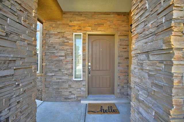 entrance to property featuring stone siding