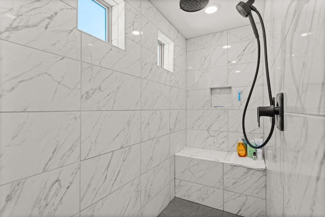 full bath featuring a tile shower