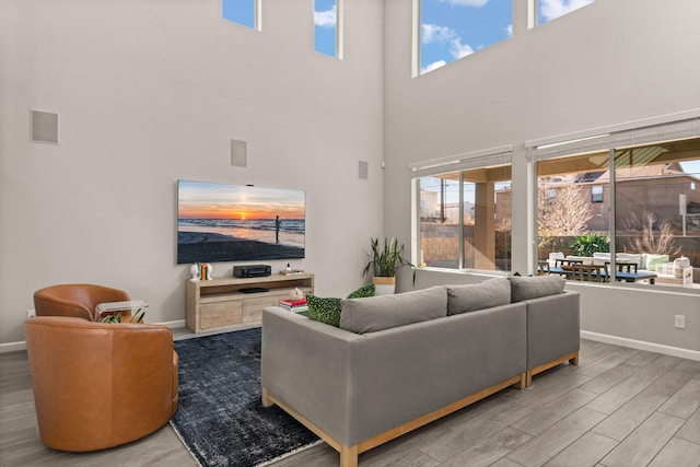 living room with plenty of natural light, wood finished floors, and baseboards