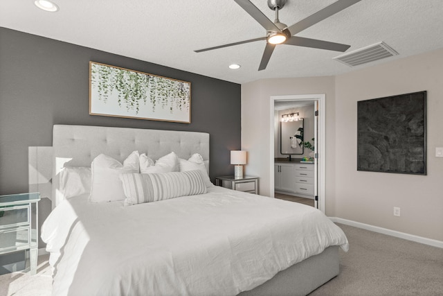 bedroom with visible vents, baseboards, a textured ceiling, and carpet flooring