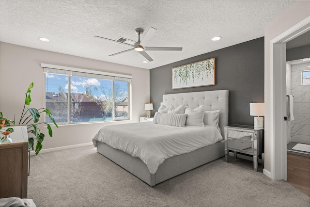 bedroom with visible vents, carpet, baseboards, and a textured ceiling