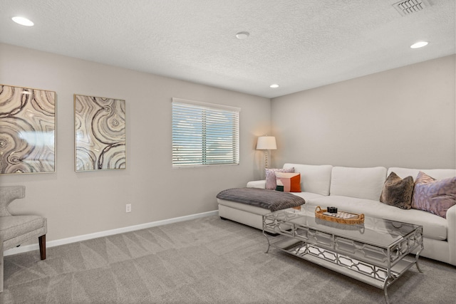 carpeted living room featuring recessed lighting, baseboards, visible vents, and a textured ceiling