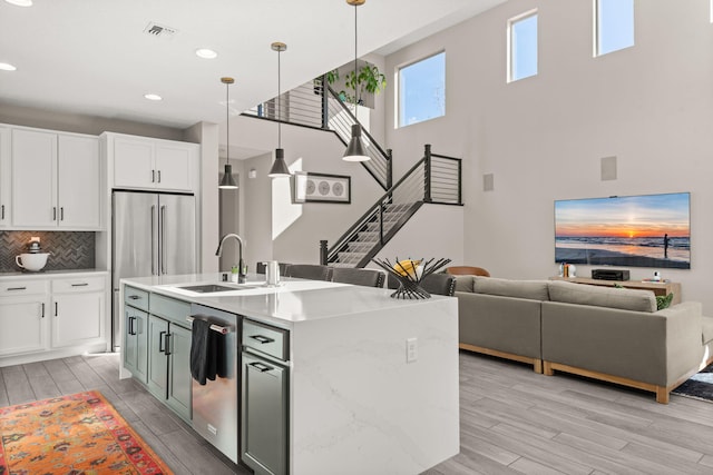 kitchen featuring visible vents, appliances with stainless steel finishes, open floor plan, and wood tiled floor