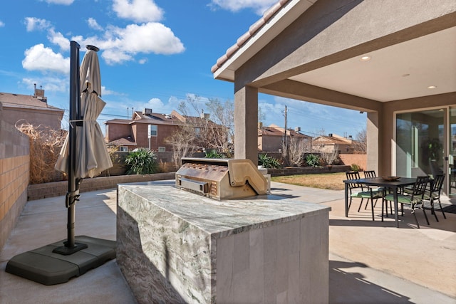 view of patio / terrace with outdoor dining area, area for grilling, exterior kitchen, and fence