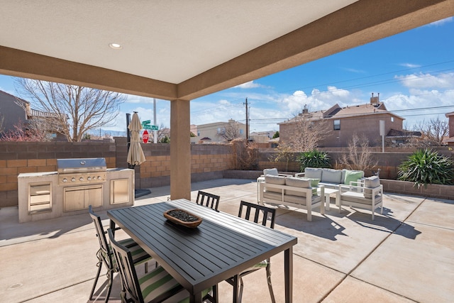 view of patio with grilling area, outdoor lounge area, a fenced backyard, outdoor dining space, and an outdoor kitchen