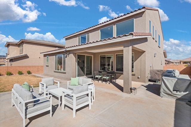 rear view of property featuring a patio, an outdoor living space, outdoor dining area, a fenced backyard, and stucco siding