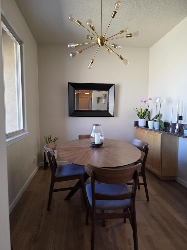 dining space with wood finished floors, baseboards, and a textured ceiling