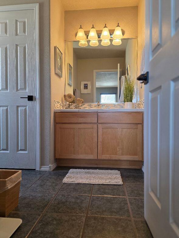 bathroom with tile patterned floors and vanity