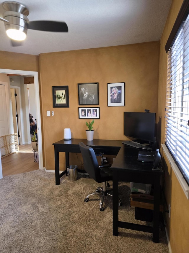 office with carpet flooring, baseboards, and a ceiling fan