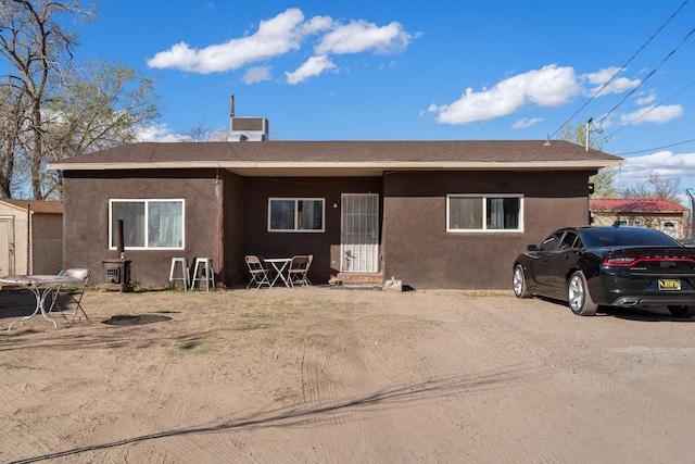 view of front of home with cooling unit and stucco siding