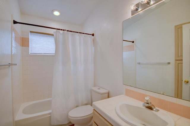 bathroom with vanity, toilet, and shower / bathtub combination with curtain