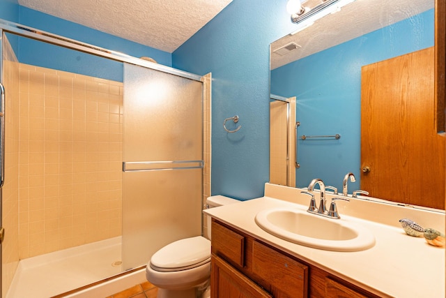 full bath featuring visible vents, toilet, a stall shower, a textured ceiling, and vanity