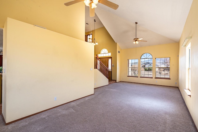 unfurnished living room with stairs, a ceiling fan, carpet, and high vaulted ceiling