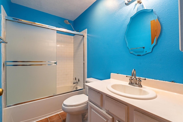 full bathroom with vanity, tile patterned flooring, a textured ceiling, toilet, and combined bath / shower with glass door