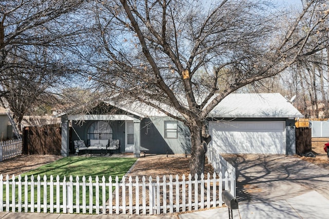 view of front facade featuring a fenced front yard, driveway, an attached garage, and an outdoor hangout area