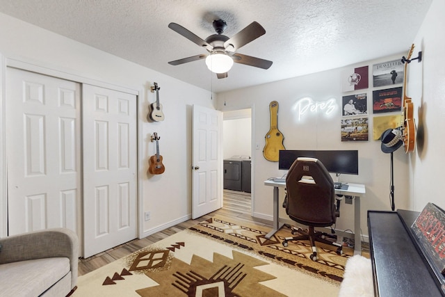 office area featuring a ceiling fan, wood finished floors, baseboards, and a textured ceiling