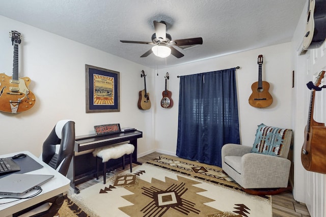 office space with ceiling fan, wood finished floors, and a textured ceiling