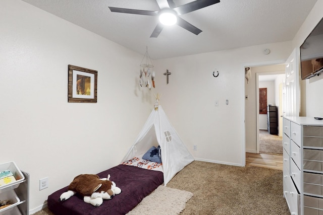 unfurnished bedroom featuring baseboards, carpet, ceiling fan, and a textured ceiling