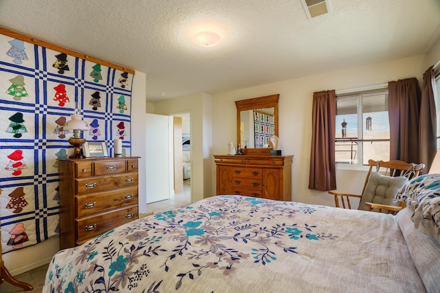 bedroom with visible vents and a textured ceiling