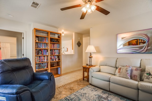 living room with visible vents, baseboards, and a ceiling fan