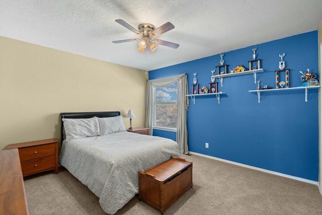 bedroom featuring carpet flooring, a ceiling fan, baseboards, and a textured ceiling