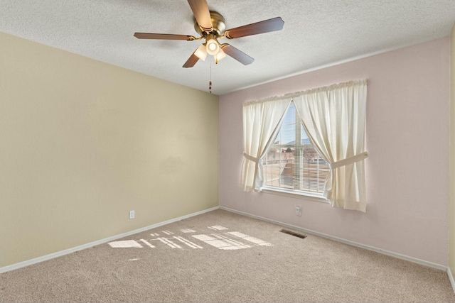 empty room featuring a ceiling fan, baseboards, visible vents, a textured ceiling, and carpet flooring