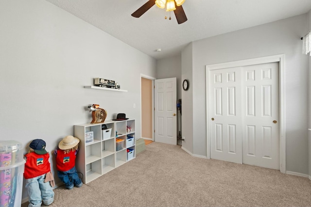 playroom with baseboards, carpet floors, and ceiling fan