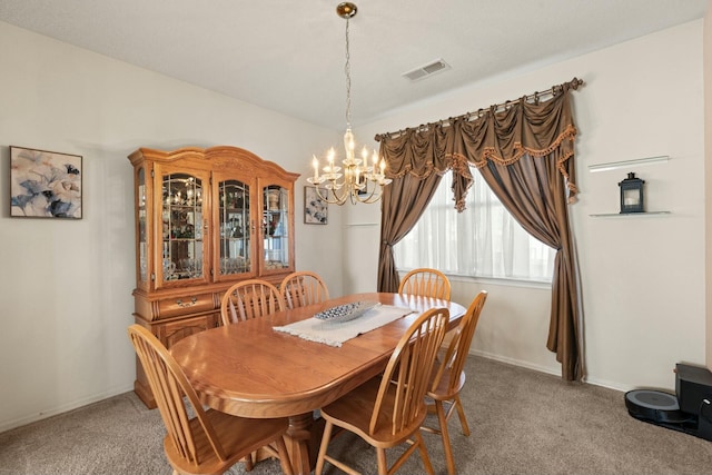 dining room featuring baseboards, light colored carpet, visible vents, and a chandelier