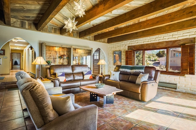 tiled living room featuring arched walkways, beamed ceiling, and a baseboard radiator